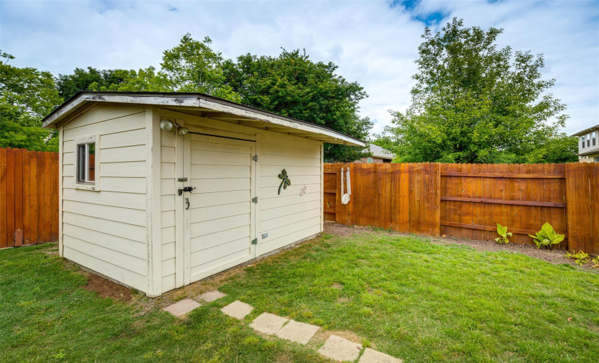 Adjacent to the patio, you'll find a meticulously crafted shed, equipped with lighting and a fully operational AC unit.
