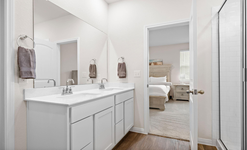 Dual sinks and an extended walk-in shower in the primary bath