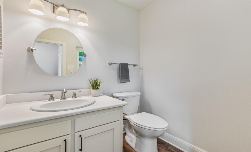 Half bathroom located near the kitchen and informal dining and near the backyard space.