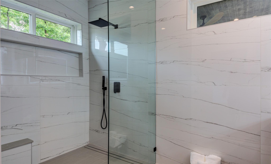 Oversized Primary shower with lighted niche spanning length of transom