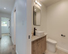 Secondary guest bath replete with walk in shower and European floating vanity.