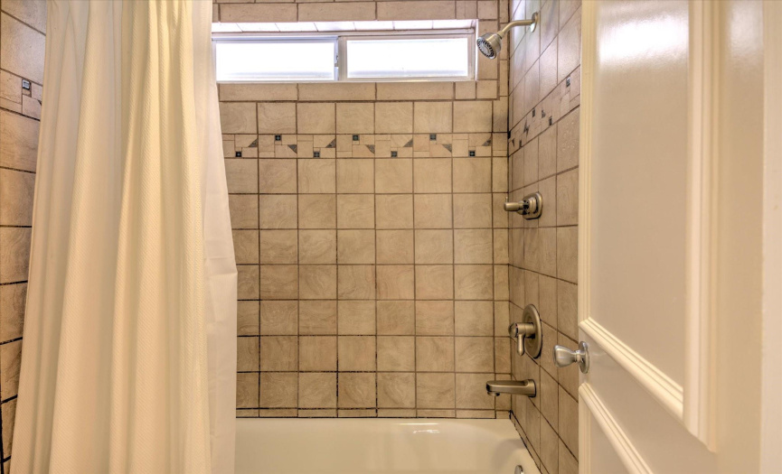 Tub and shower combo in primary bathroom