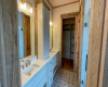 En-Suite Bathroom with Barn Door, Tile Floors, Walk-in Tile Shower with Glass Door, Toilet Room, Walk-in Closet with built-in shelving, White painted wood cabinets, soft close and porcelain countertops, double sinks
