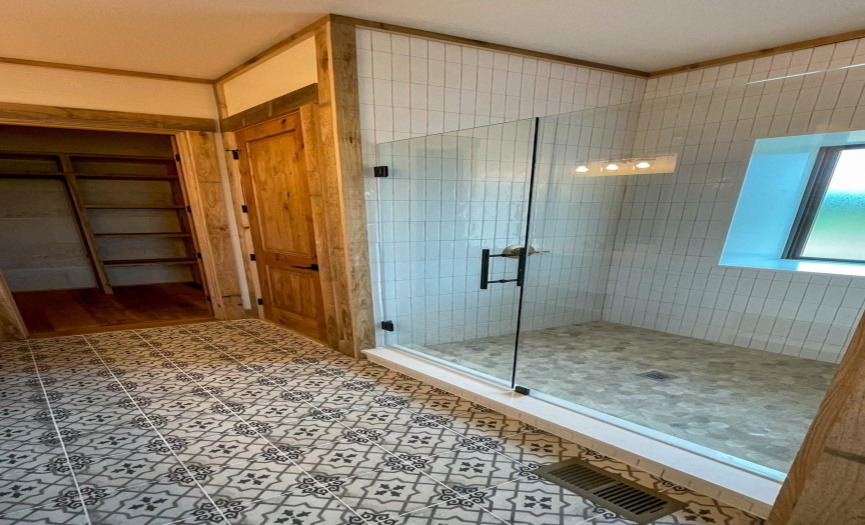 Walk-in Tile Shower with Glass Door & walk-in Closet with built-in shelving