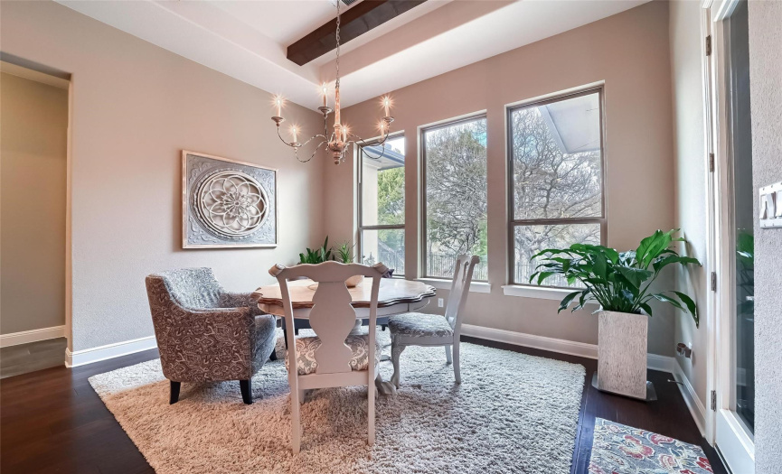 Note the tray ceiling with wood beams in the large secondary dining area. It's a special spot for casual meals where the sun shines in & the backyard beauty can be enjoyed.