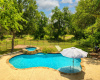 Beautiful 3-year new pool with hot tub and lots of room for outdoor living areas, umbrellas and entertainment space.  Thats all your land behind the fence and beyond!