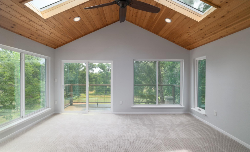 Stunning custom sunroom addition with views of the land and pool.