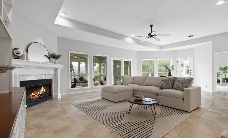 Multiple living spaces for entertaining with a formal living room and this welcoming family room wrapped in windows that infuse the space in natural light and provide serene views. 