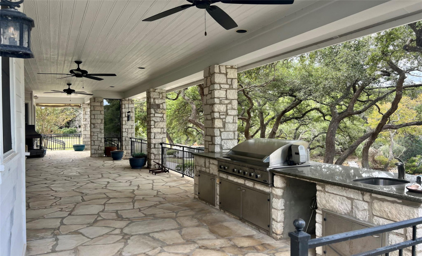 Outdoor kitchen overlooking pool and patio