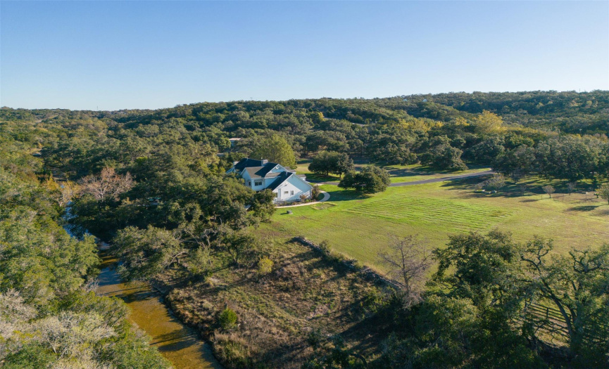 Stately, Country home overlooking the creek and green pastures.