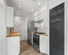 A unique feature of this kitchen is the pantry door, which doubles as a chalkboard. This creative touch adds a fun and practical element, allowing you to jot down grocery lists, recipes, or simply doodle to your heart's content.