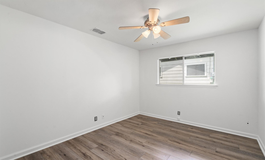 One of three secondary bedrooms, is spacious and inviting with ample natural light and a serene ambiance.  