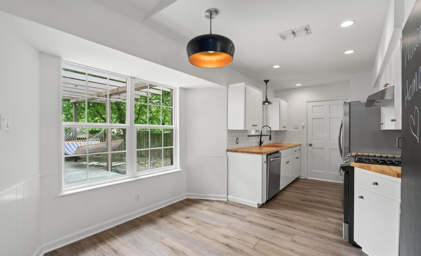 The kitchen also features a charming dining space that leads seamlessly into the family room. Picturesque windows allow the indoor and outdoor spaces to create a cohesive setting, perfect for entertaining.