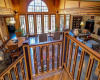 View of the Great Room and custom intricate woodworking on the stair railing