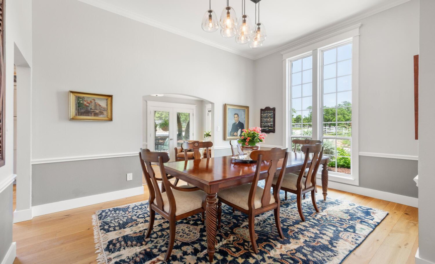 Elegant dining room overlooks the circular drive and front pasture