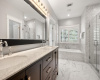 Gleaming primary bath with soaker tub and walk-in shower