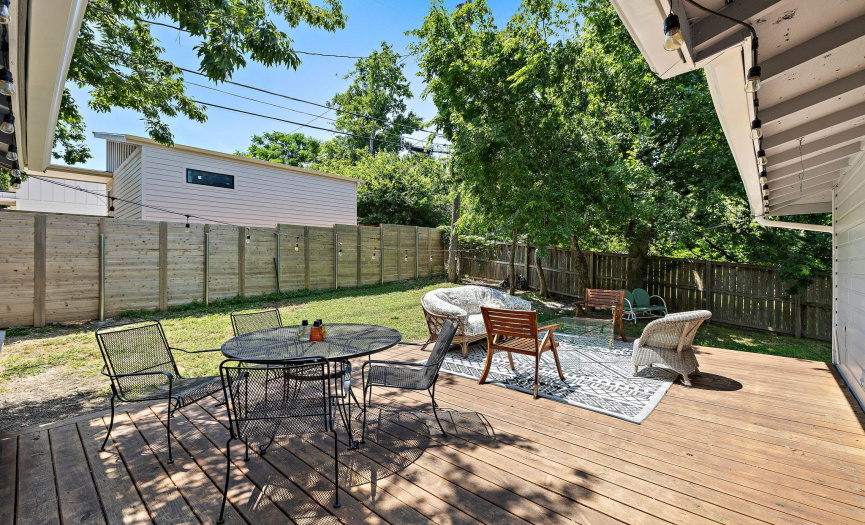 Large deck is naturally shaded by trees. Big enough to accommodate both living and dining.