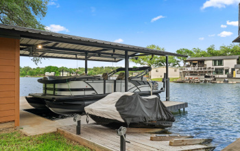 Custom boathouse with 25ft boat stall and dual waverunner hoist. 