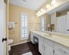Large Primary bathroom with Sitting Vanity on Wood-Style Tile