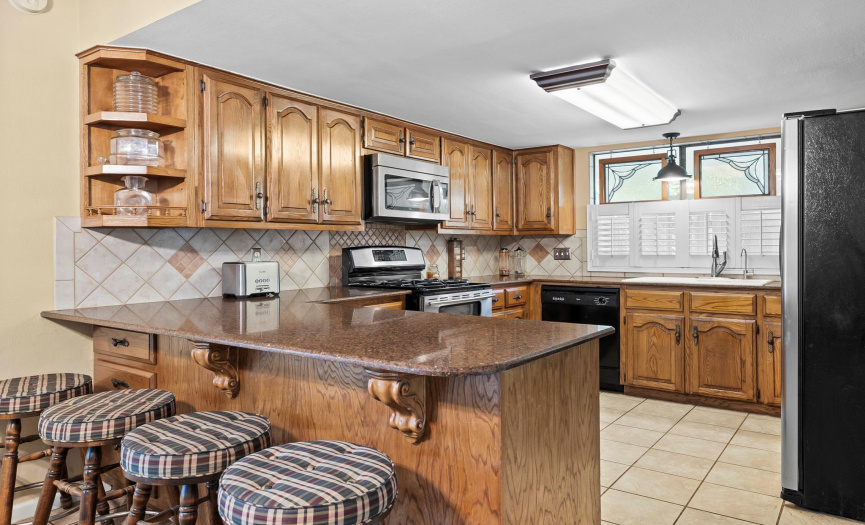 Open kitchen with granite counter top with gas cooktop inspirers  your best cooking 