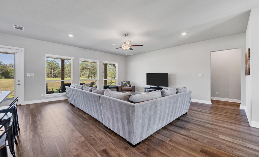 The spacious living room, with tons of natural light, offers a bright, airy atmosphere, perfect for relaxation or entertainment. And the convenience of remote-controlled window shades adds a modern touch to the space.