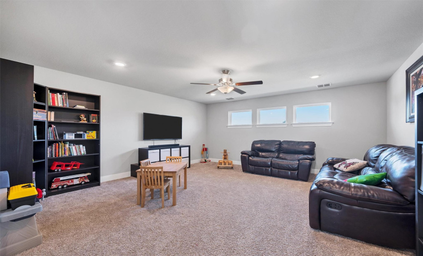Upstairs, the expansive loft or game room area offers endless possibilities for customization. Whether you transform it into a home theater, office, or game room, this versatile space will surely be a favorite among guests.