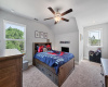 Bedroom with plush carpeting, a ceiling fan, and a little nook area.