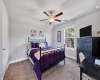 Another bedroom with plush carpeting, and a ceiling fan.
