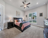 The Tranquil primary bedroom is a peaceful retreat featuring plush carpeting, recessed lighting, and a ceiling fan. You'll love recharging in this space.