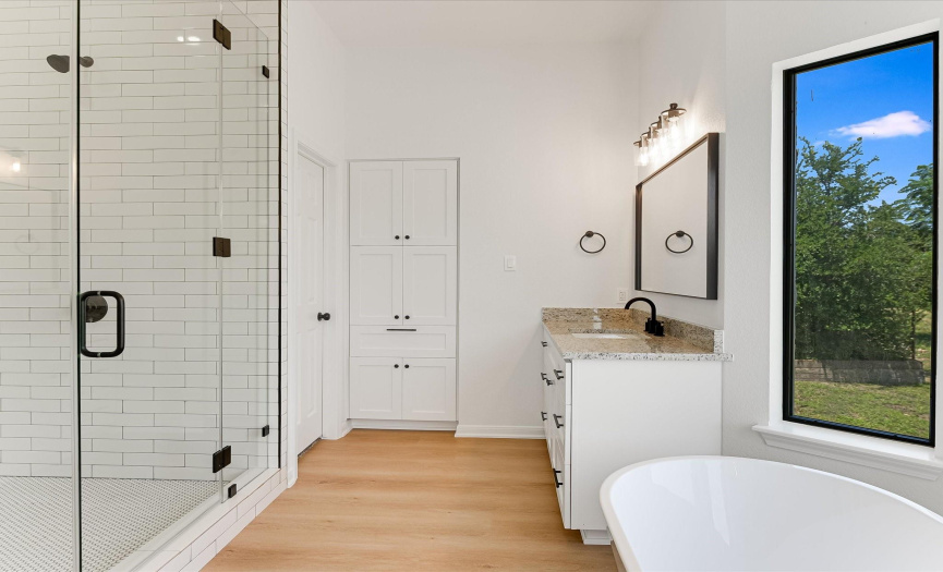 Primary bathroom with a soaking tub and walk in shower and 2 walk-in closets