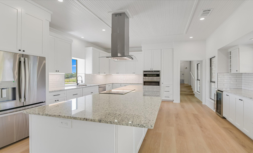 Gourmet kitchen with stainless steel appliances, granite countertops, brand new custom cabinets