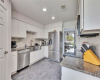 Gorgeous kitchen with stainless steel appliances in granite countertops.