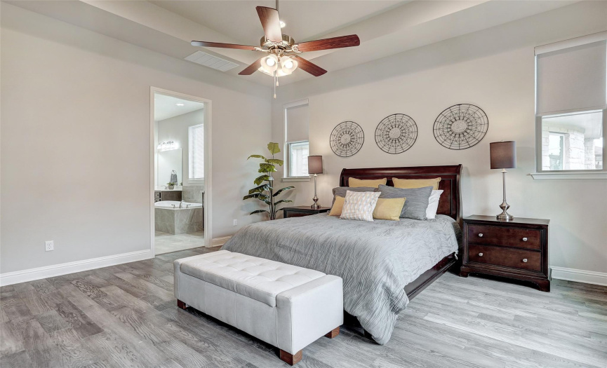 There's so much space to curate your perfect sanctuary with an 11 foot tray ceiling and wall of windows with plenty of room for a King bed and sitting area.