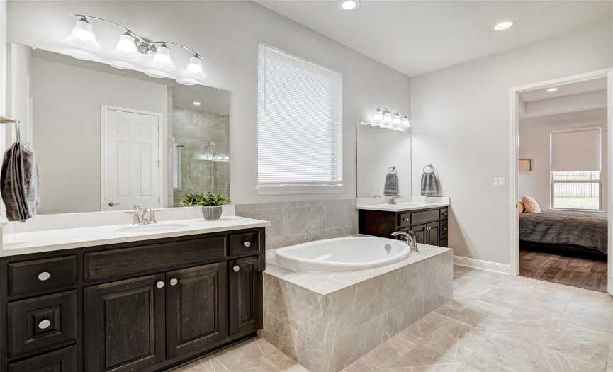 Take me away Calgon in the spa like primary ensuite with dual vanity, large soaking tub and massive walk-in glass enclosed shower.  The finishes are exquisite!