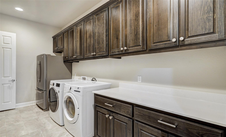This may be one of the biggest laundry rooms you have ever seen with an abundance of cabinet space for storage and room for an extra refrigerator.  The laundry connects to the primary closet and is adjacent to bedroom 3 and 4. 