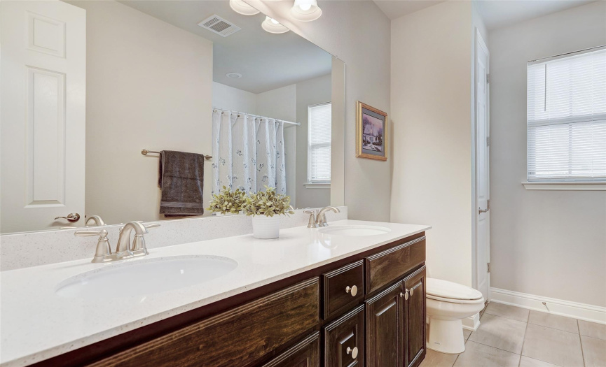 A roomy guest bath with 2 sinks and a tub/shower combo can be shared by bedroom 3 and 4.