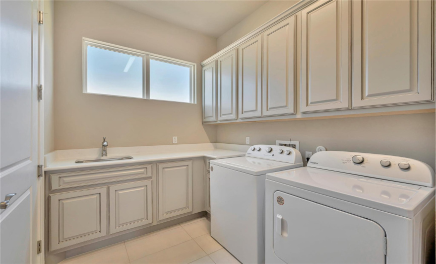 The laundry room can be entered directly from the garage or off the entry hall. It includes new washer and dryer, lots of cabinets and a storage closet.