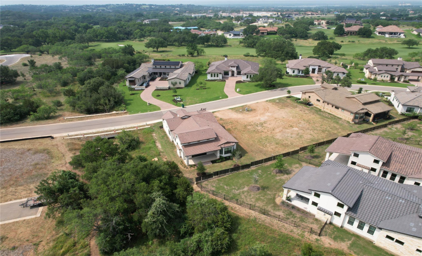 Arial view showing rear of home and the million dollar homes on other side of the street.