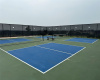 Three pickleball courts are adjacent to the clubhouse.
