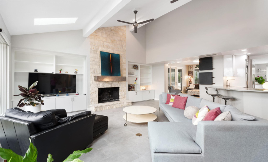 Soaring ceilings, custom built-ins, and beverage bar enhance main living room.