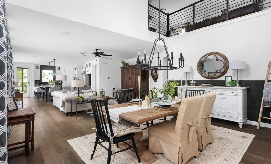 Sophisticated Dining Space: Enjoy the sophisticated dining space, seamlessly integrated into an open concept layout with high ceilings, enhancing the room's elegance.