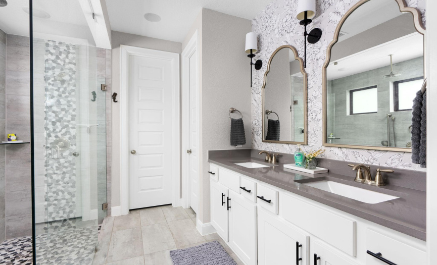 Luxurious Primary Bath with Dual Vanities: Discover the epitome of luxury in this primary bath, featuring dual vanities with elegant countertops and ample storage. The spa-like ambiance is enhanced by the soothing color palette and exquisite lighting fixtures.