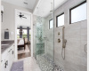 Primary Bath Oasis with Huge Shower: This primary bath is an oasis of tranquility, offering an enormous shower with frameless glass doors, dual showerheads, and exquisite tile detailing. The spacious design ensures a spa-like experience every day.