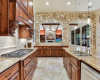 This gourmet kitchen features gorgeous granite countertops, stainless steel appliances, a double sink and a cooktop.