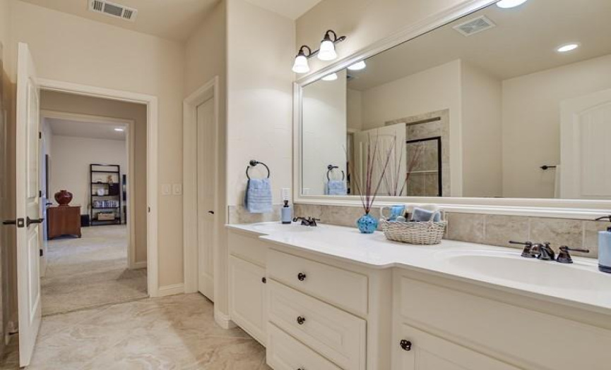 Upstairs bathroom with tiled walk-in shower, separate tub and double vanities.