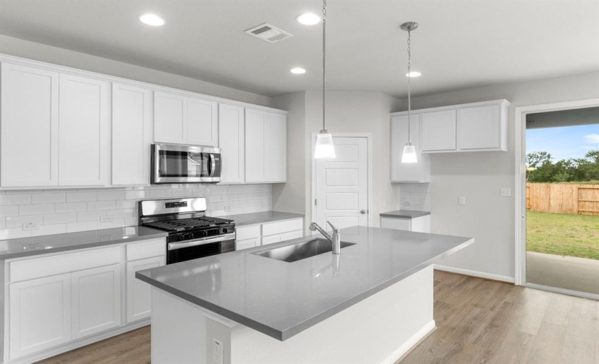 Kitchen: Shaker White Cabinets, Grey Quartz countertops, pendant lights, gloss - subway tile backsplash 