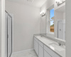 Primary Suite Bathrom:Designer selections, Privacy door for toilet, Walk-in Shower and double vanity. Cabinet Height is raised.