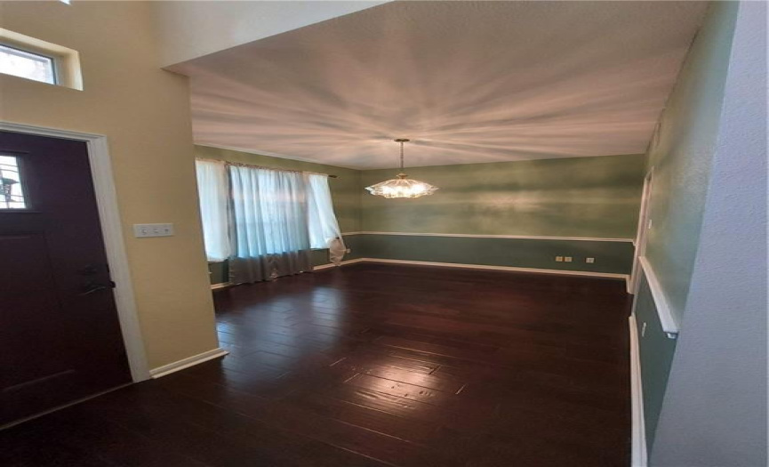 Walk in to formal area with gorgeous wood flooring leading into living room and master bedroom. 