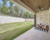Huge covered patio with stone wall fence. 