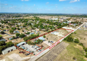 View of entire property; developed portion on the left, and undeveloped portion with driveway to 7200 sq. ft concrete pad ready for your business needs.